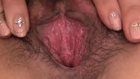 Rika Aina, amateur Japanese woman, fondles her choking pussy in fishnet stockings