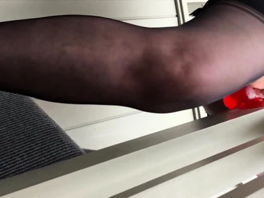 Busty redhead indulges in solo play with dildo on stairs