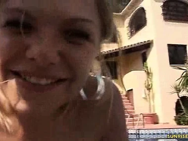 A man's penis is orally pleasured outdoors by a pool