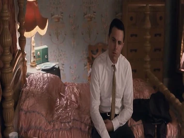 Jessica Alba poses on stomach with pants down on bed